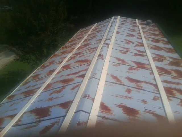 Rusted metal roof panels with new wood purlins before replacement — Storm Damage Roof Repair in Spartanburg by Roofing Brothers