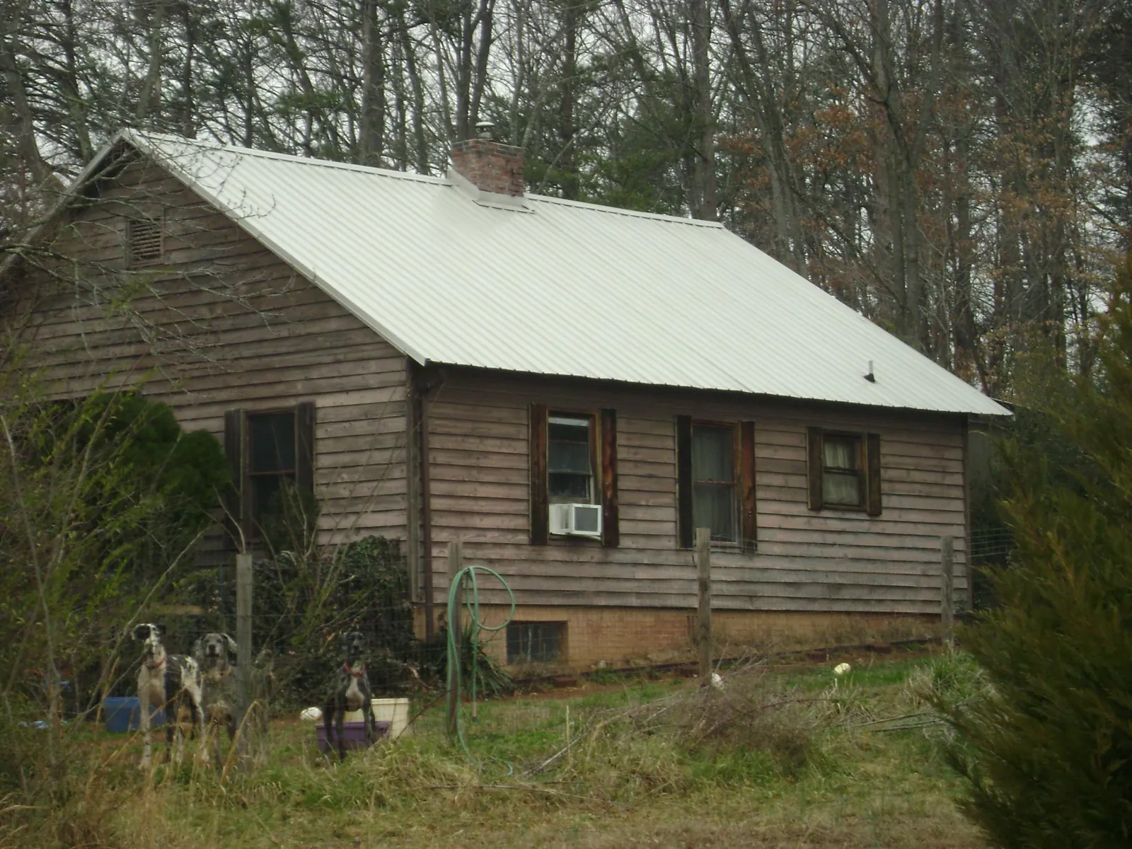White metal roof on an old wood sided farmhouse, from a Metal Roof Installation job in Spartanburg