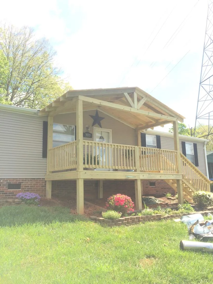 New gabled porch roof and deck railing added to a ranch home in Spartanburg